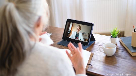 Sick senior woman having video call with doctor, telemedicine and online therapy.