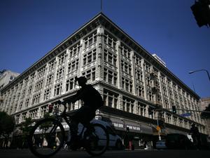 Bicyclist passes the corner of 8th and Broadway where the Broadway Trade Center, an enormous 100-ye