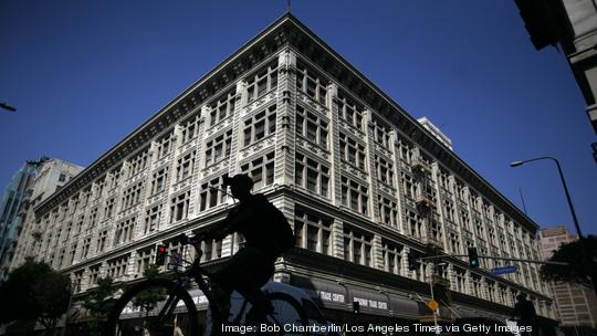 Bicyclist passes the corner of 8th and Broadway where the Broadway Trade Center, an enormous 100-ye