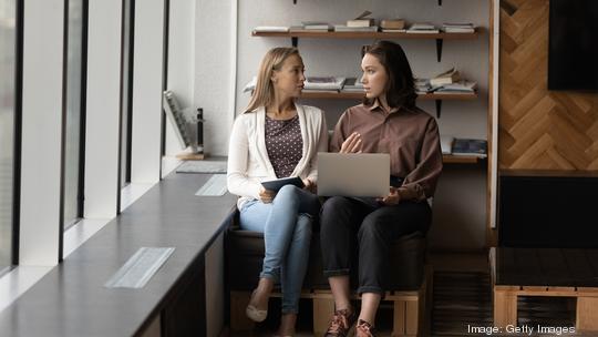 Engaged millennial business woman, employees, coworkers meeting in office lounge