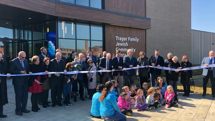 Gov. Andy Beshear and other local officials, members and children of the Trager Family Jewish Community Center pose of a ribbon cutting on the new facility.