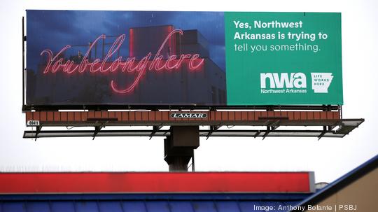 Northwest Arkansas billboard, this is trying to draw (tech) workers away from the Puget Sound region to that Central State is seen on Aurora Ave. N. in Seattle,