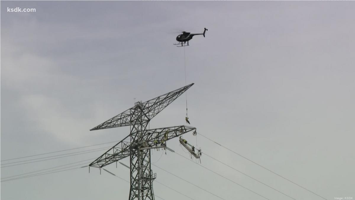 crews-hang-from-helicopter-to-install-new-power-lines-across