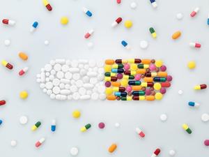 Medical pills and tablets in shape of drug capsule and scattered