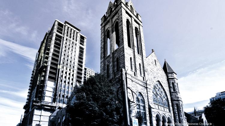 A 26-story apartment tower is rising on top of a once-vacant lot next to the century-old St. Mark United Methodist Church.