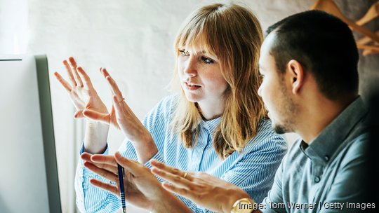 Colleagues Problem Solving At Computer Together start a new business