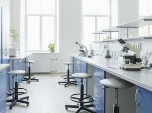 Microscopes at desk in bright empty laboratory