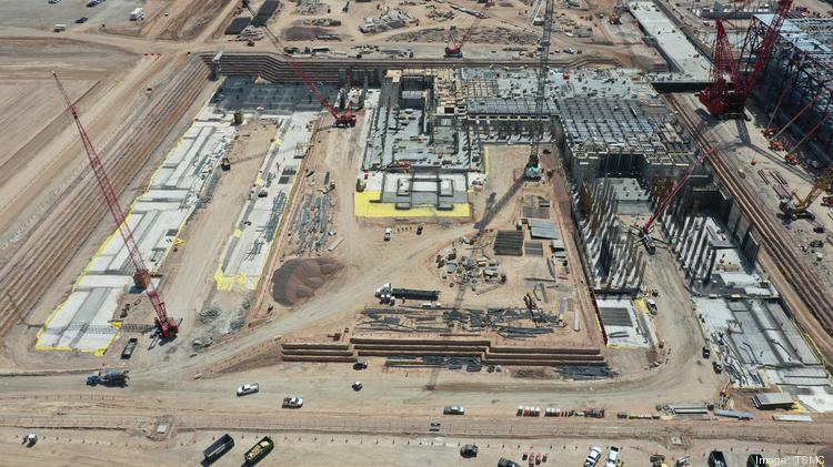 Aerial photos show TSMC construction progress in May 2022, about a year after breaking ground. TSMC reported in an earnings call Thursday it hired 900 workers in Arizona for its north Phoenix fabs.