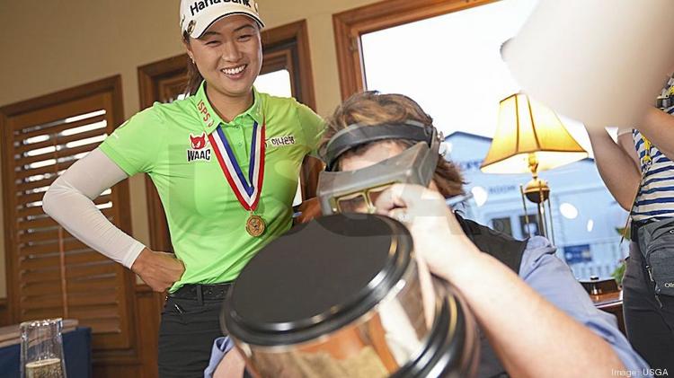 Minjee Lee watches an engraver add her name to the trophy after winning the 2022 U.S. Women's Open Presented at Pine Needles Lodge & Golf Club in Southern Pines, N.C. on June 5.