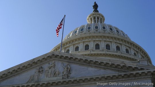 USA Capitol Building dome with American flag flying.