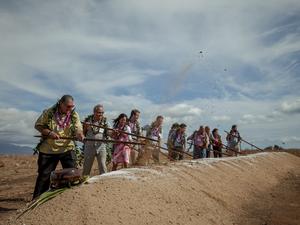 Turning of the earth using o‘o sticks. The first three people shown from left to right are Maui Mayor Michael Victorino, Bernerd Da Santos, Executive Vice President and Chief Operating Officer of AES, and Sandra Larsen, Hawaii Market Business Leader for A