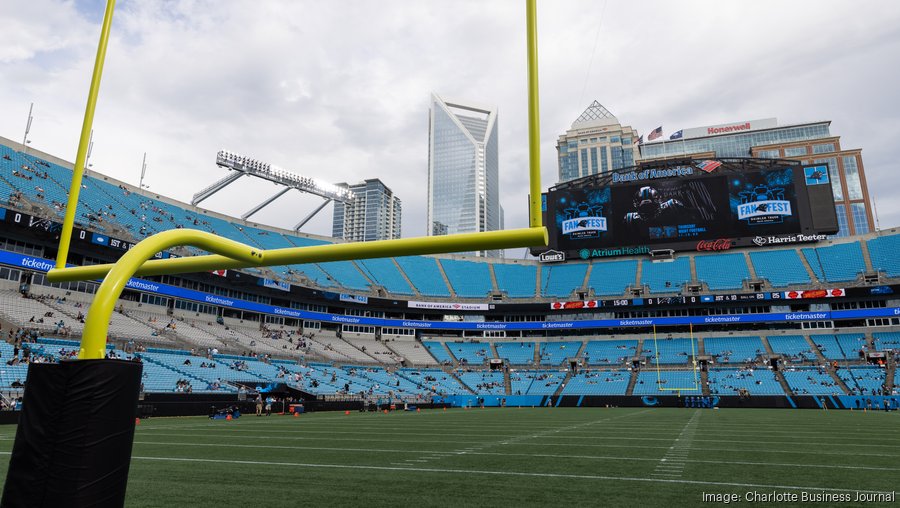 Carolina Panthers owner David Tepper hauls a team-themed Santa Claus along  the bench area prior to playing the Atlanta Falcons on Sunday, Dec. 23,  2018 at Bank of America Stadium in Charlotte