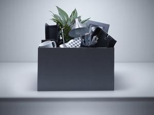 Box packed with desk objects