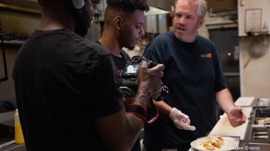 Hill preparing on the set of Esco Eats food series.