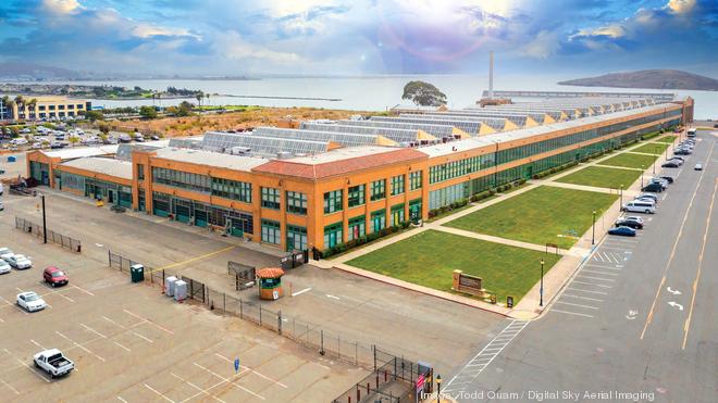 View from top of power plant looking towards office building. The  photograph captures Shipley & Lodge Manufacturing Company. The image  showcases the Hert Theatre plant on the left foreground, a warehouse in