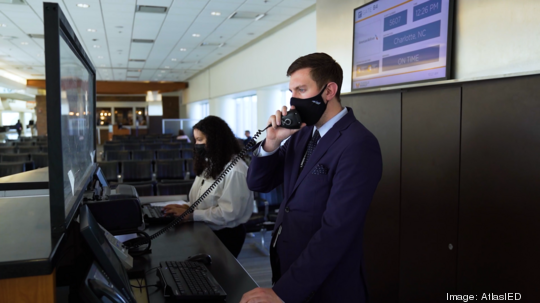 SDF Video Still - Gate Agent Using Mic Station Med