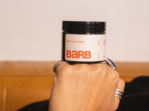 Barb Pomade jar resting on hand