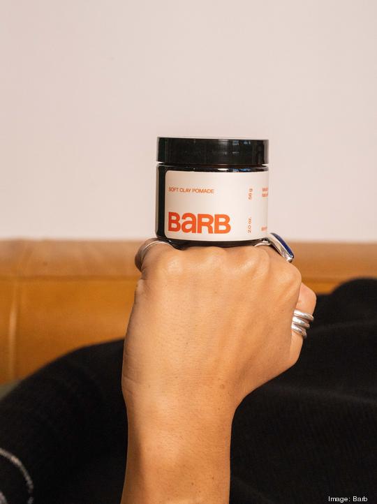 Barb Pomade jar resting on hand