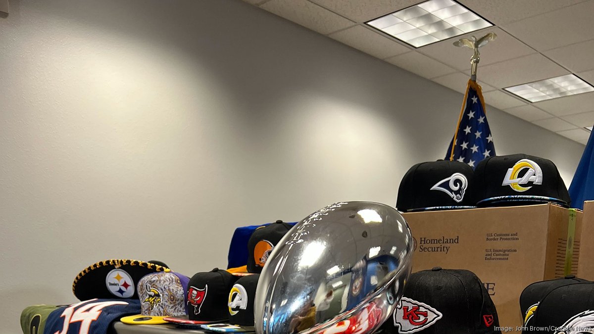 An NFL offical holds up sample authentic Super Bowl XLII tickets during the  counterfeit tickets and merchandise press briefing at the Super Bowl media  center in Phoenix on January 31, 2008. Phoenix