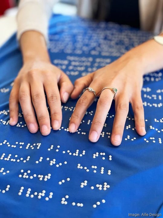 Reading braille blue dress