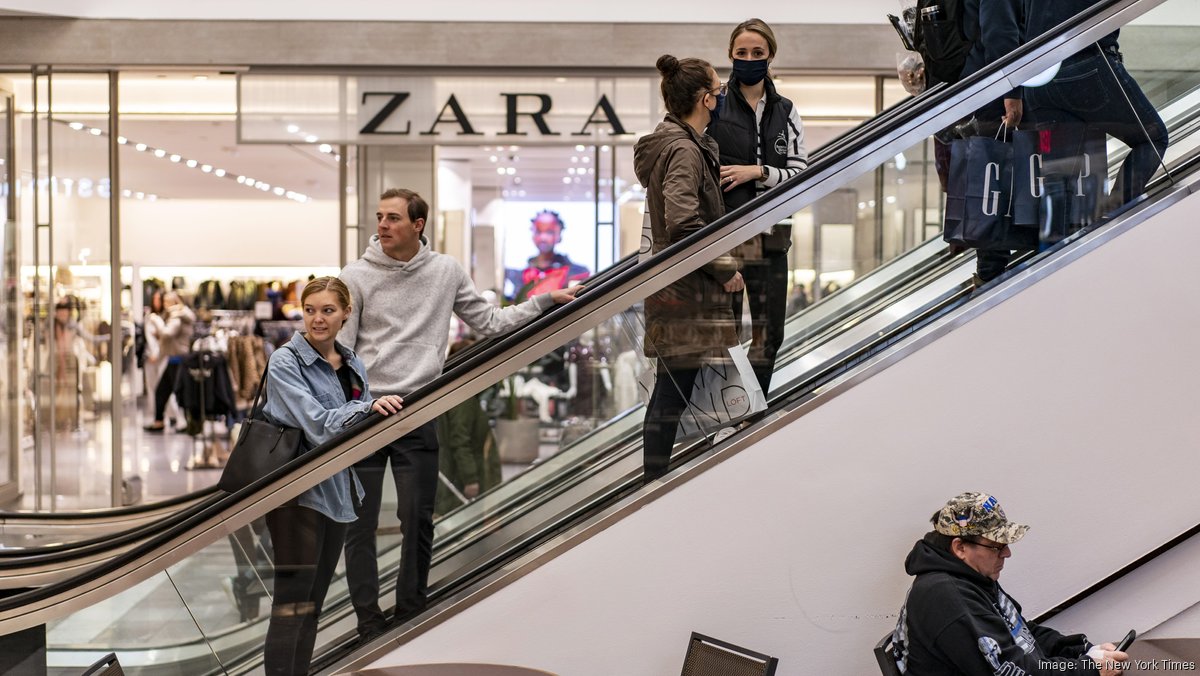 A sales clerk places clothes in the new Zara megastore at