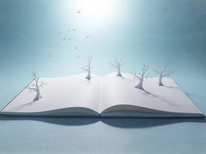 Pop-up book withpaper forest and flock of birds