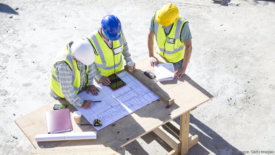 Contractors blueprints construction site