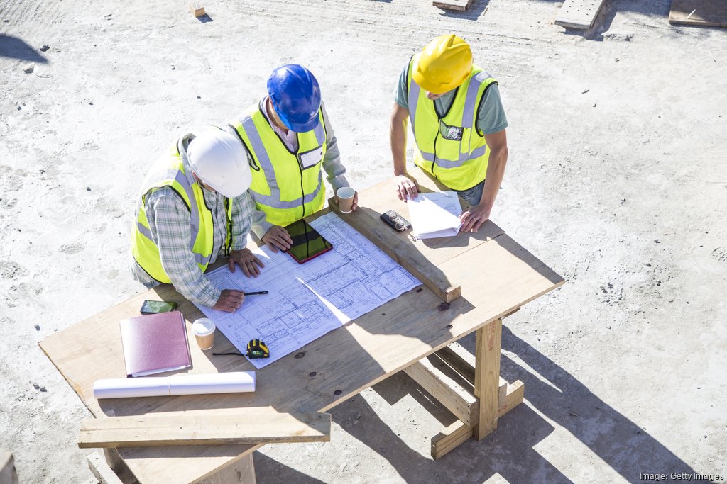 Contractors blueprints construction site