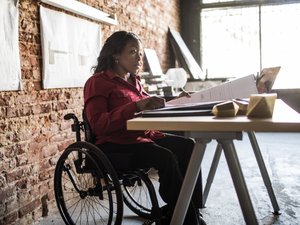 Businesswoman in wheelchair working at desk