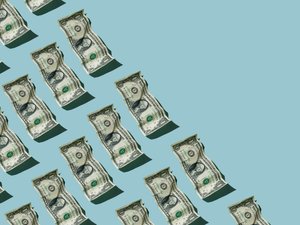 Crumpled one dollar bills on blue background