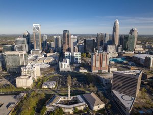 Aerial View of Charlotte, North Carolina on clear day showing highways and skyline