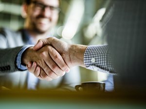 Close up of businessmen came to an agreement in the office.