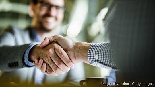 Close up of businessmen came to an agreement in the office.