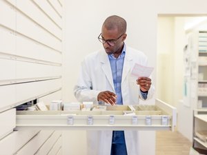 Pharmacist looking for prescription medication