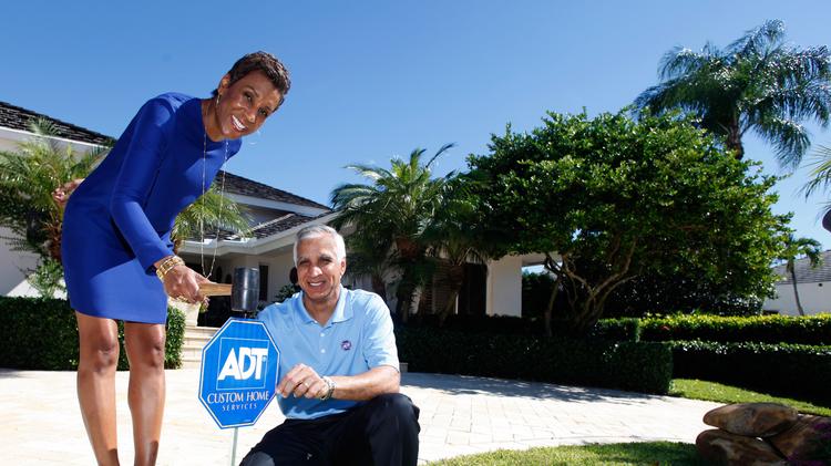 Adt Protection 1 Merge Following 6 9b Private Equity Out Adt Cmo Jerri Devard And Ceo Naren Gursahaney Plant An Yard Sign At The Home