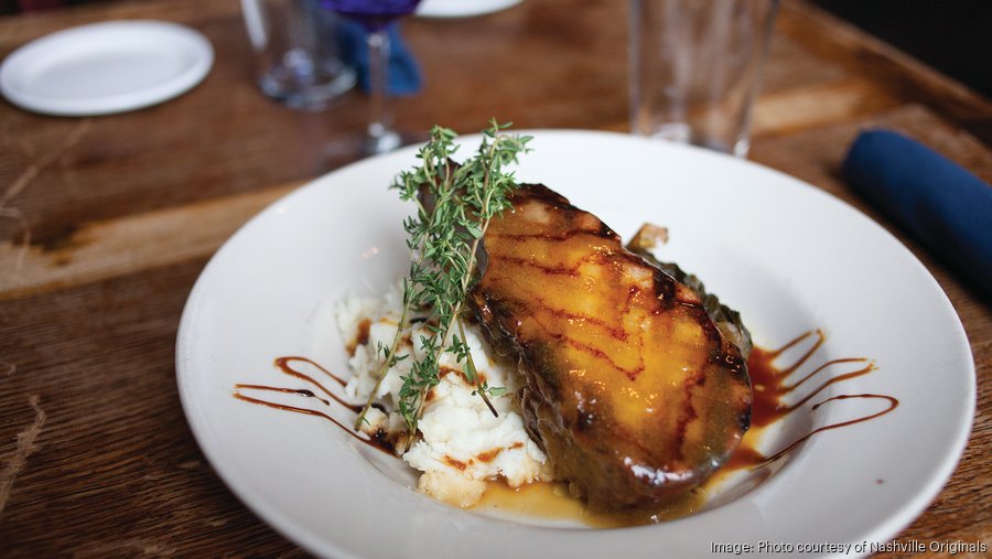 Tandy Wilson handing Mop/Broom Mess Hall to RJ Cooper, new concept