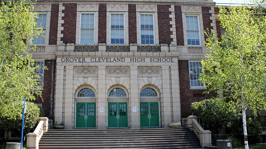 School building with sign saying "Grover Cleveland High School"