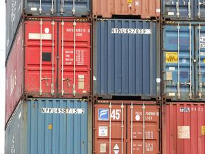 Shipping containers sit waiting to support commerce around the Port of Seattle in Seattle, Wash.