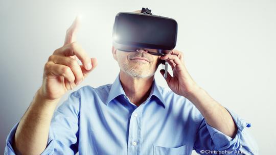 Professional Man Using Virtual Reality Headset And Mobile Phone